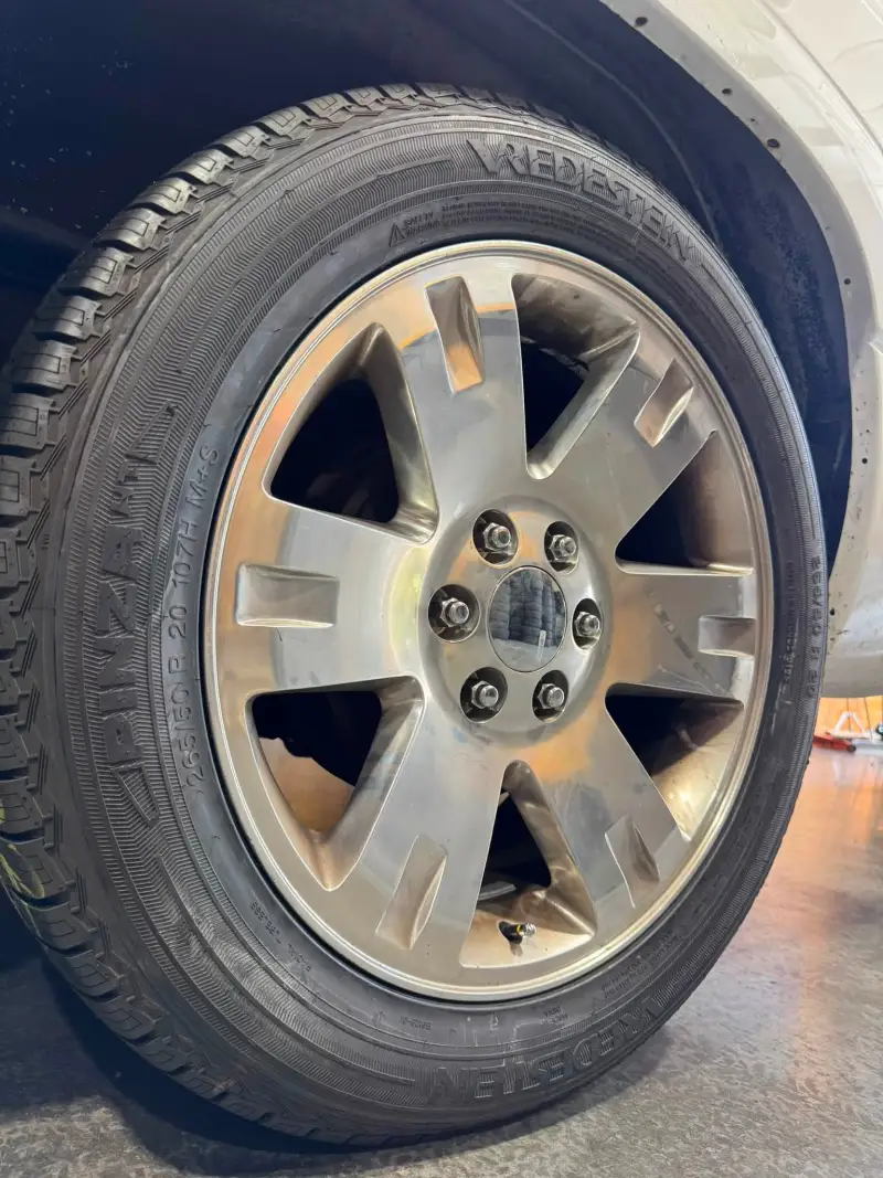 A new Vredestein tire mounted on a customer's alloy wheel in the Blessed Beginnings bay